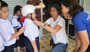 Properly-sized helmets protect students' heads.