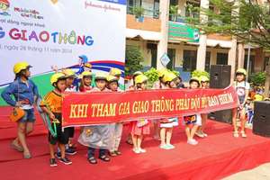 Students promote helmet safety messages on stage.