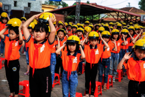 Students participate in Helmet handover ceremony