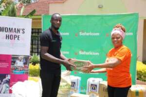 Safaricom handing over donations to our director