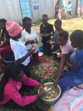 Young girls prepare food for the celebration
