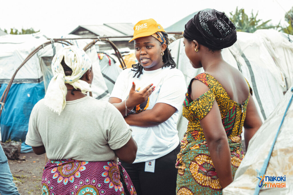 Dr. Celestine Buyibuyi speaking with two women