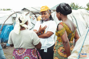 Dr. Celestine Buyibuyi speaking with two women
