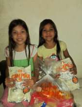Students holding milk from food bag delivered