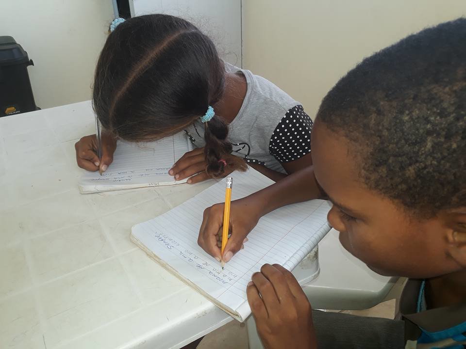 Children work on writing.