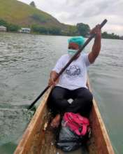 Midwife Lili Suebu travelling across Lake Santani