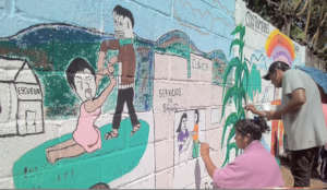 Painting a wall for visualize women rights