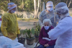 Nurses taking care of an older adult in a LTCF