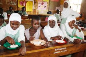 Girl students enjoying lunch together.