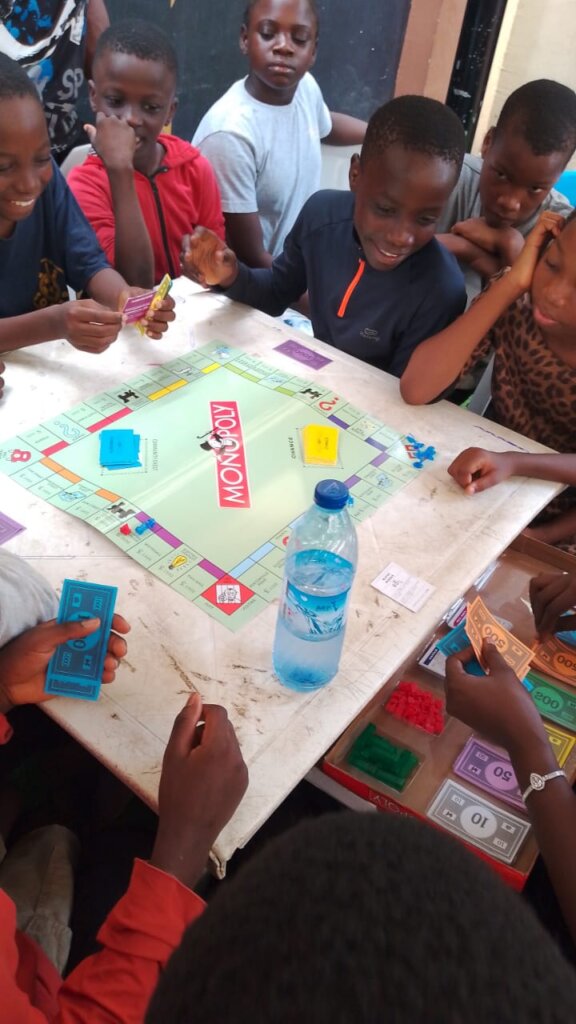 Tabitha Home Children Learning to Play Monopoly