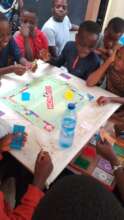 Tabitha Home Children Learning to Play Monopoly