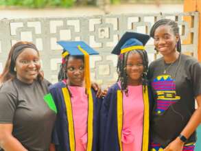 Two Primary School Graduands with their Caregivers