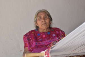 Maria weaving on her backstrap loom