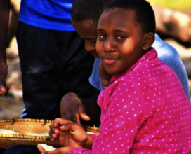 The kids helping get dinner going at Amani!