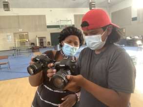 Students learn to use cameras. Photo: Kim Bautista