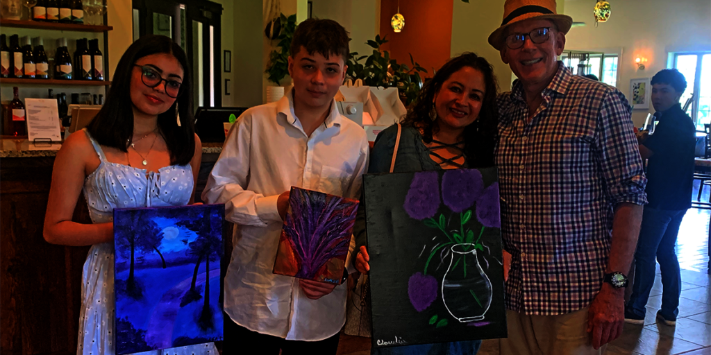 Artists with the collector who purchased their art