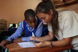 Volunteer helping a learner.
