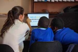 Volunteer Helping Kids Learn Folder Creation