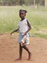 Young girl carrying home her hygiene pack