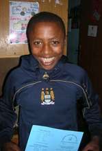 Alemu proudly showing his graduation certificate