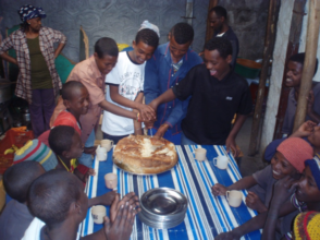 Departing boys cut bread to share with friends