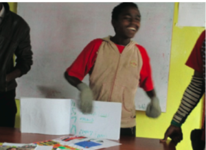 A child decorates his name