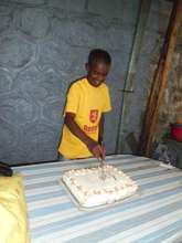 Teshome cuts the cake to celebrate