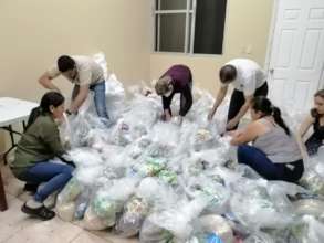 The Red COMAL team prepare emergency kits