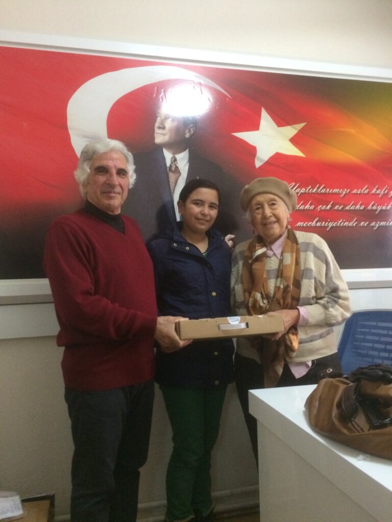 Student receiving laptop at CYDD Branch