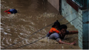 A man and his daughter struggle to leave a flooded