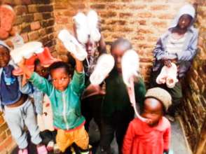 Children selecting shoes after Laundry Thursday