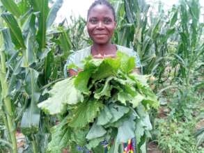 Woman farmer joyfully harvests her vegetables