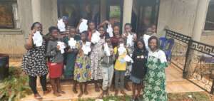Girls displaying the reusable pads they have made