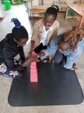Maureen, Linet and Evelyne with the Pink Tower