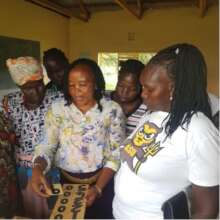 Gladys showing teachers some of the materials