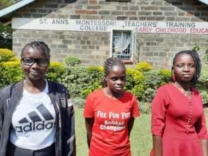 Evelyne, Maureen and Linet in front of the college