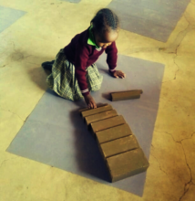 Child in East Pokot working with the Brown Stairs