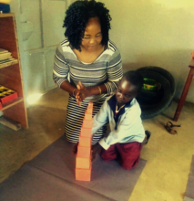 Mentor Gladys and child with the Pink Tower