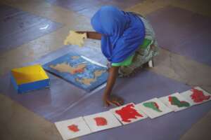 Child working with puzzle map