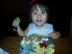Little Charlet enjoying dinner
