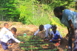 Agronomist Elijene with 3rd graders in the garden.