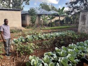 A teacher stands in one of the 22 school gardens.
