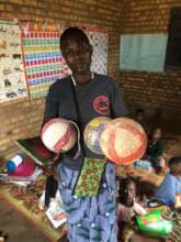 A lady standing with soccer balls