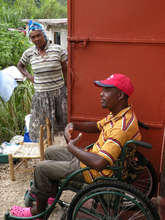 Robert outside his home in Haiti