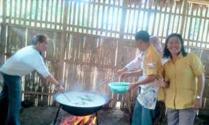 Parents and volunteers prepare meals for children