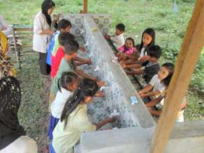 Children wash hands in new school wash facility
