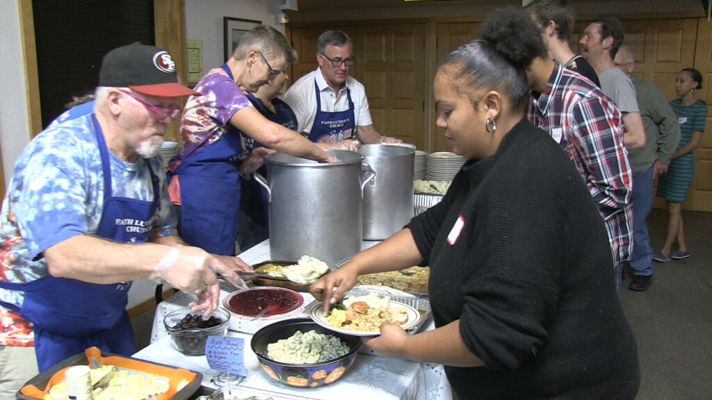Volunteers Feeding Residents a Community Meal