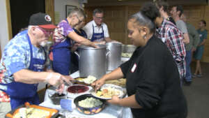 Volunteers Feeding Residents a Community Meal