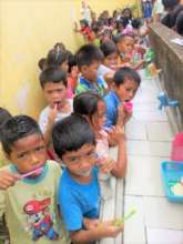 Brushing teeth at school wash station