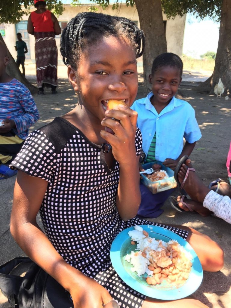A student enjoying a sweet potato for lunch